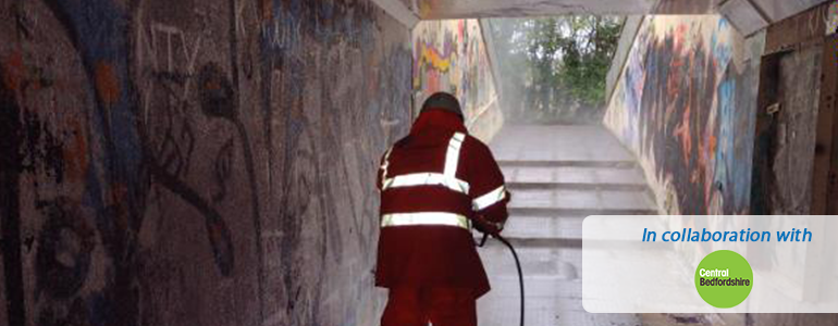 Graffiti being removed from underpass